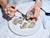Woman eating oysters off of a Dinner Plate using Black Satin Flatware.