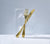 Brushed Gold Fork and Knife embedded in a block of ice with a light background.