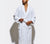 Man modeling the Essential White Classic Bathrobe with white background.