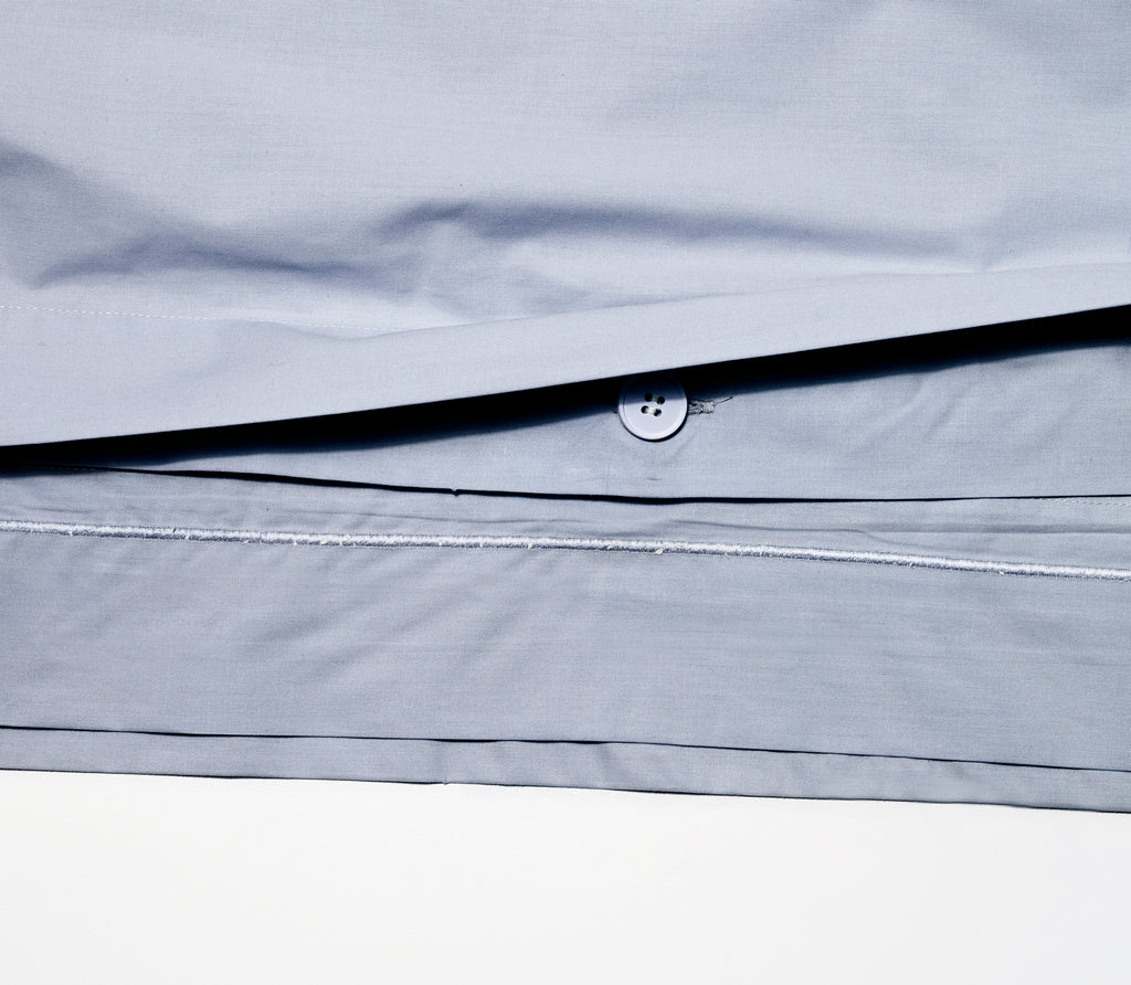 Close up of Slate Blue Percale Duvet Cover showing texture and inside buttons.