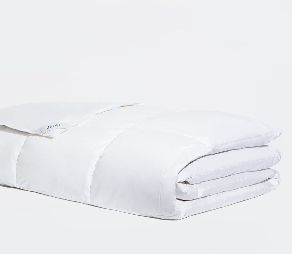 Folded white Down Alternative Comforter with white background.