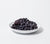 White porcelain Dinner Bowl with a mound of blueberries inside with a white background.